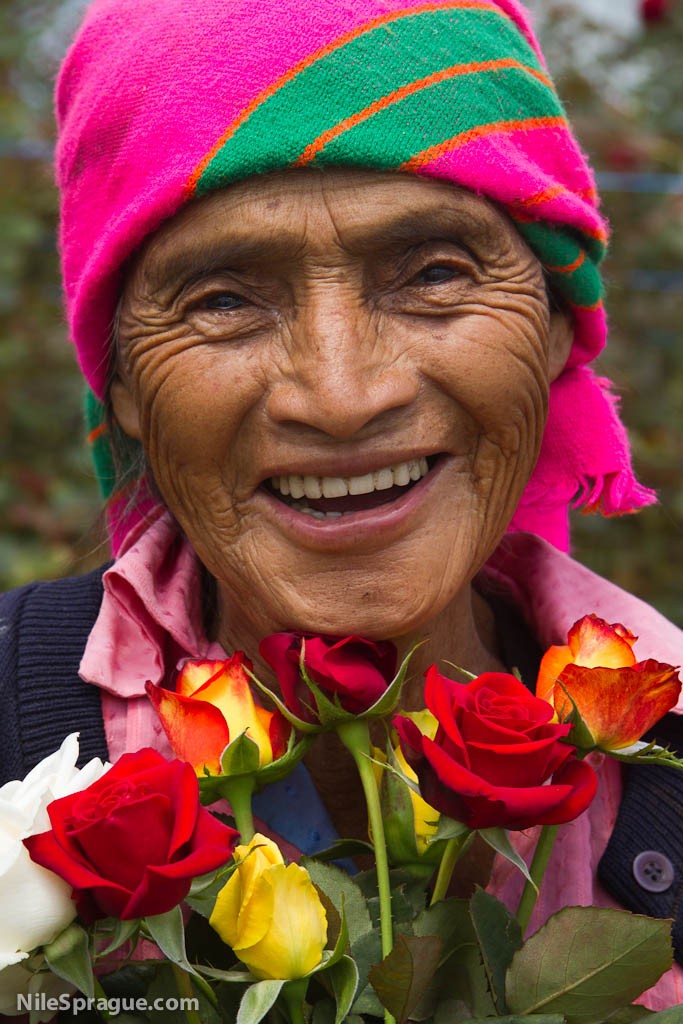 Ninety-four year old woman smiling with bouquet of roses